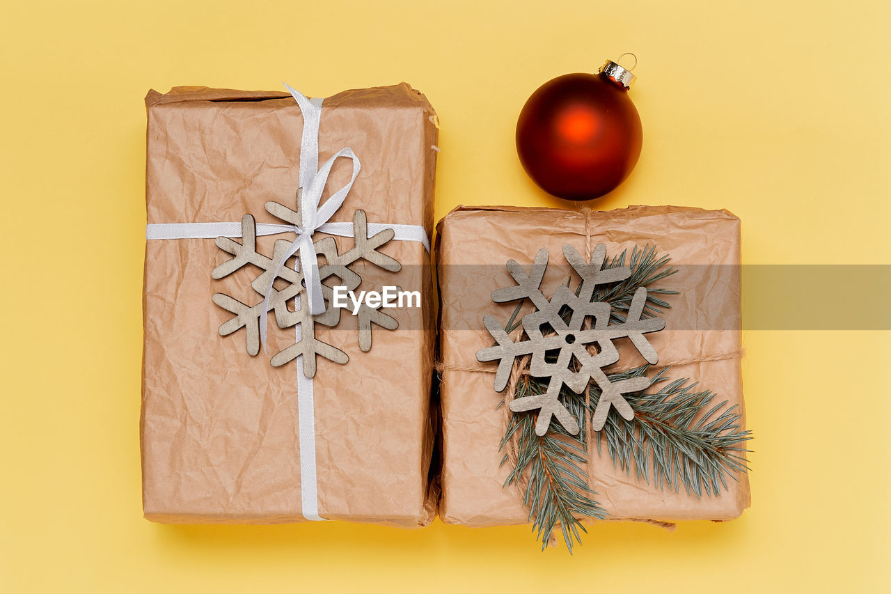 directly above shot of christmas decorations on yellow background