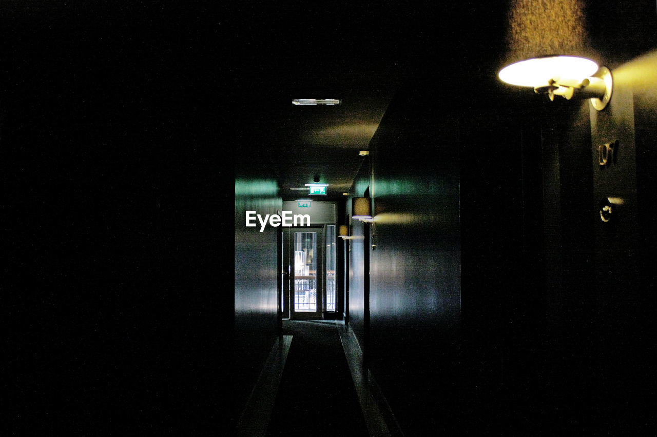 ILLUMINATED UNDERGROUND WALKWAY AT NIGHT