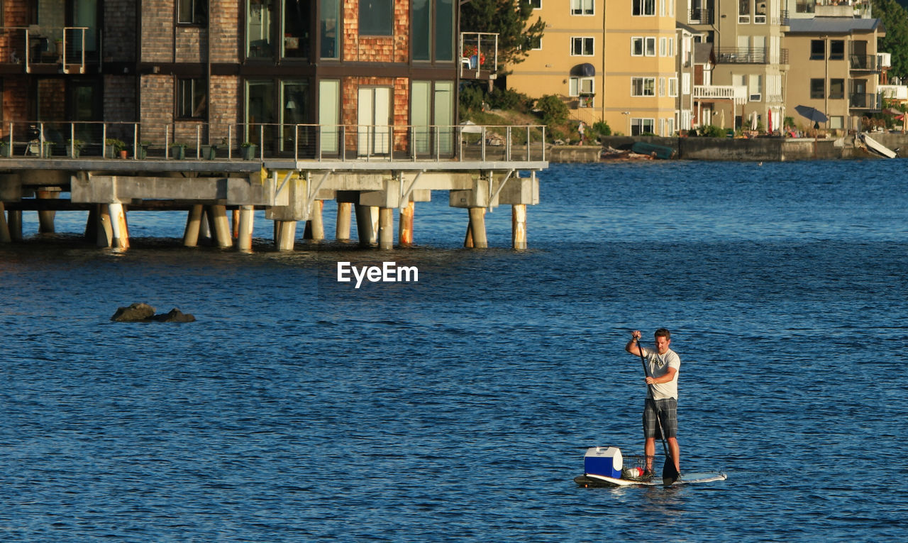 High angle view of man paddleboarding in sea