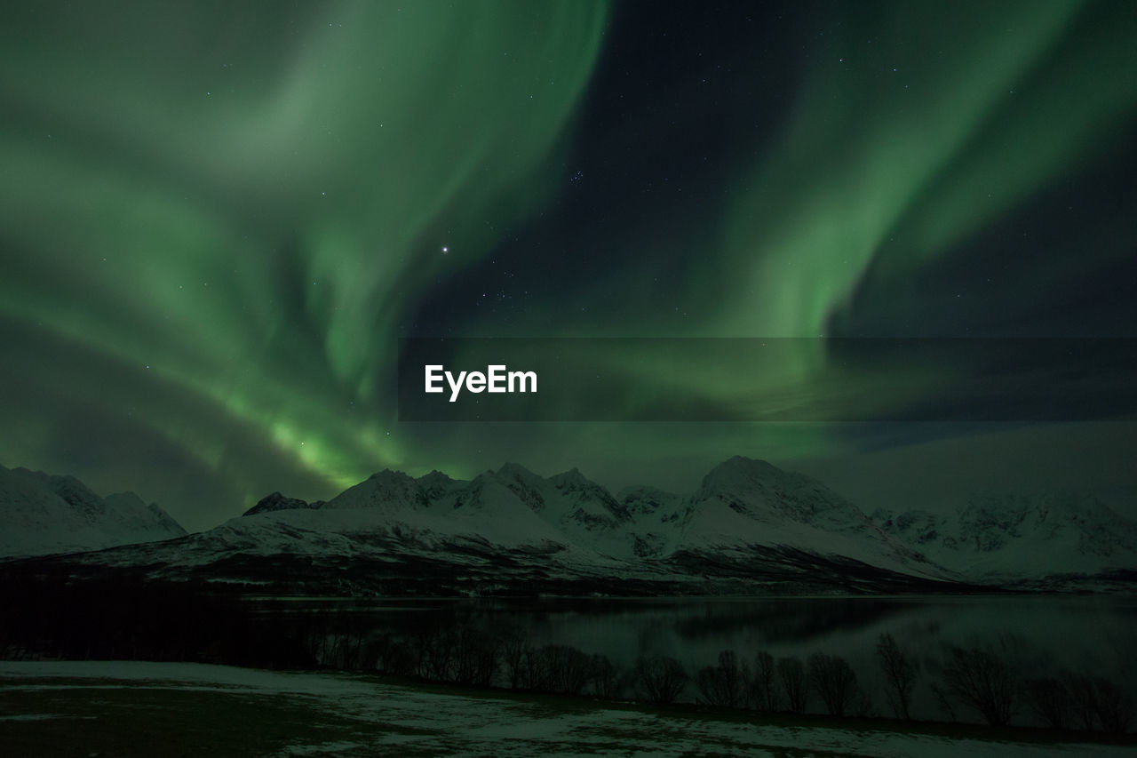 Scenic view of aurora borealis over lyngen alps