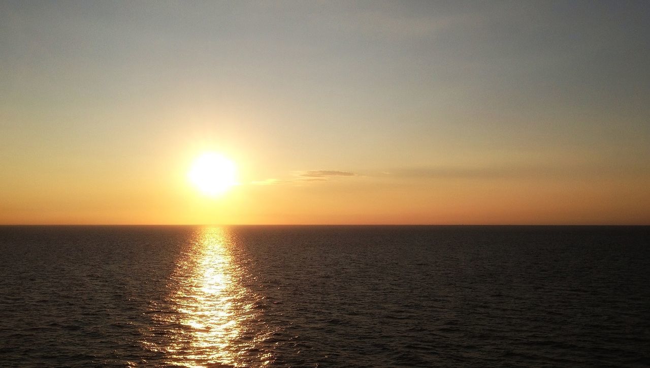 Scenic view of sea against orange sky