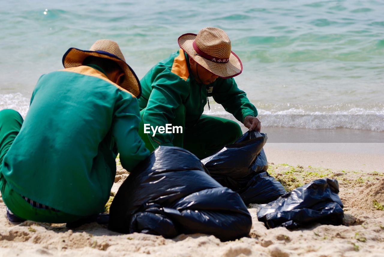 PEOPLE SITTING ON BEACH