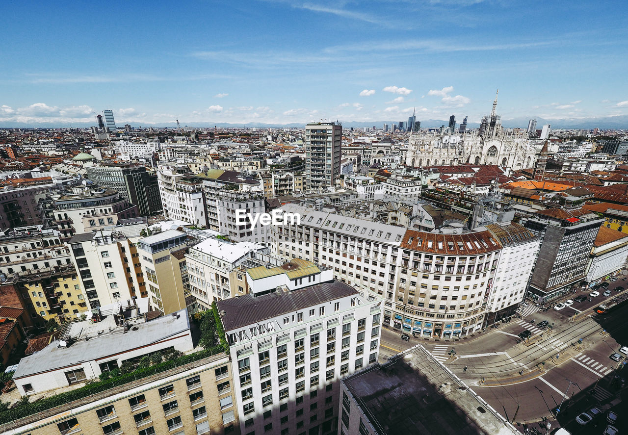 Aerial view of cityscape against sky during sunny day