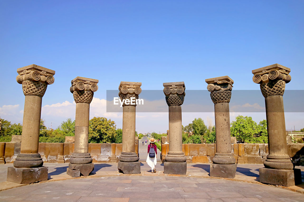 Female visitor at zvartnots cathedral, amazing unesco world heritage site in armenia