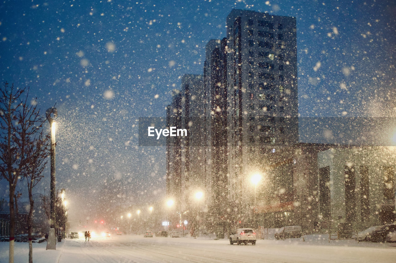 View of city street during winter at night