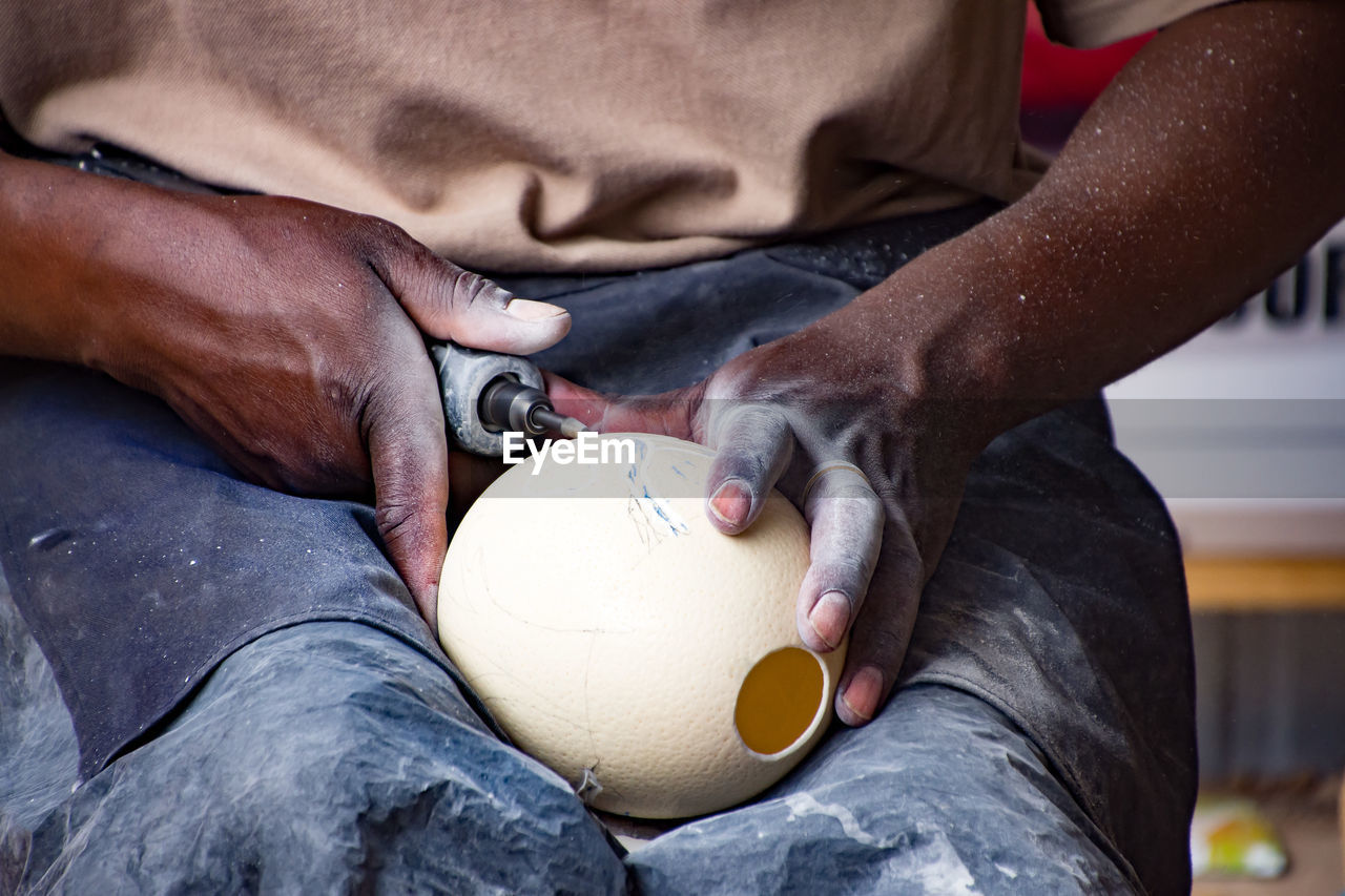 CLOSE-UP OF MAN WORKING WITH HAND