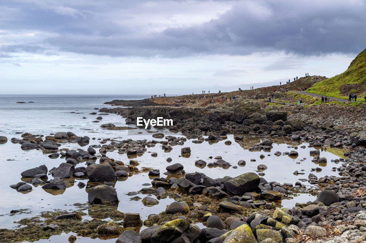 Rocks on beach against sky