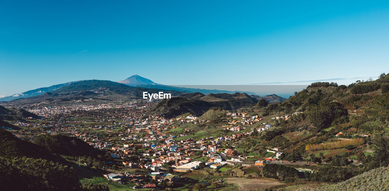 Scenic view of mountains against clear blue sky