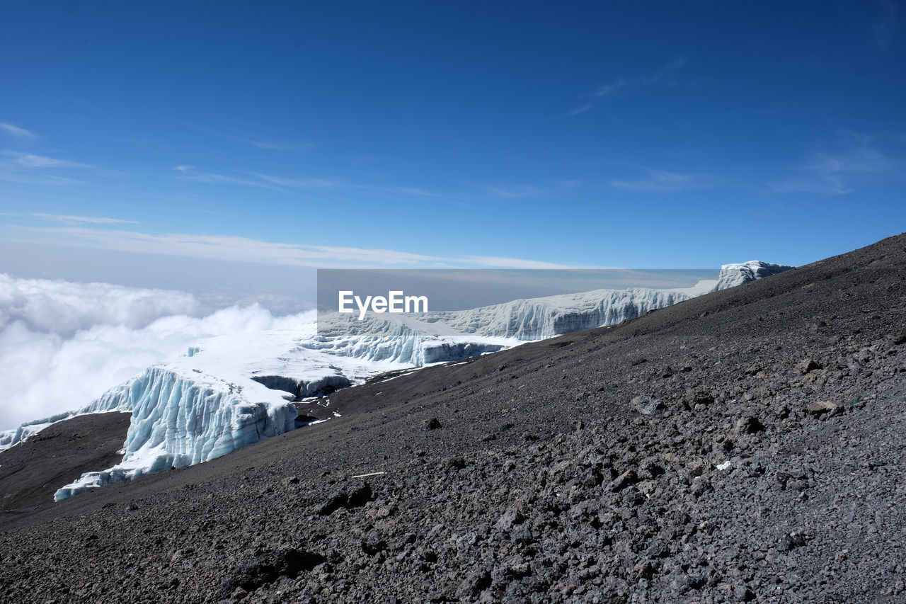 Scenic view of landscape against blue sky