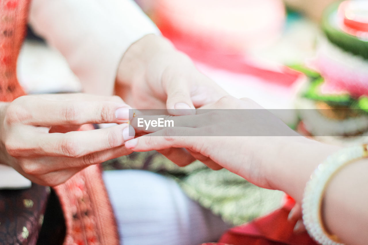 Midsection of couple during wedding ceremony