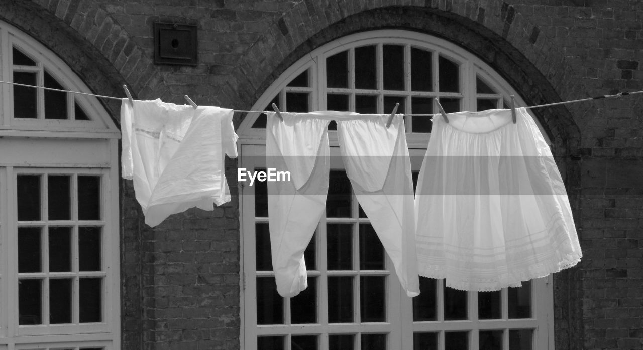 Clothes drying on clothesline outside building