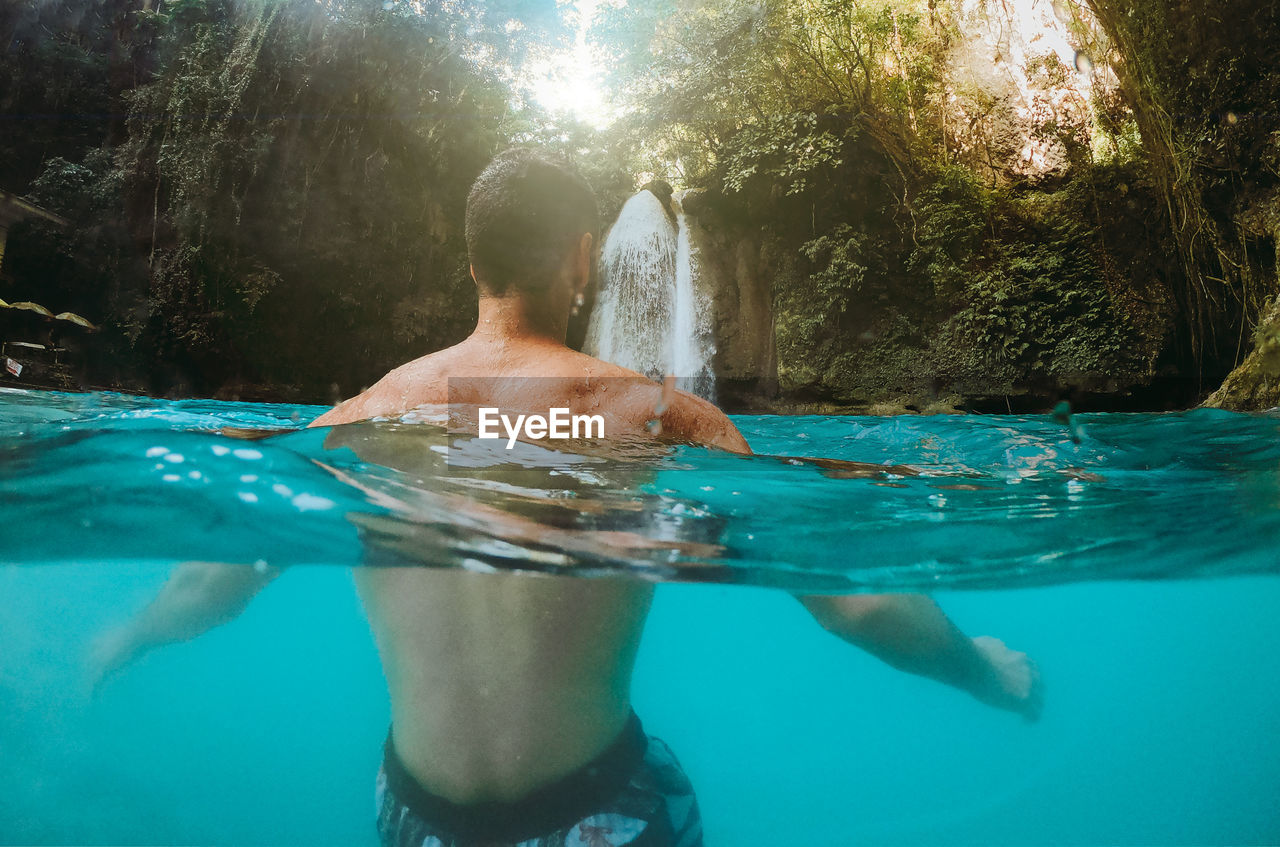 Man swimming in water