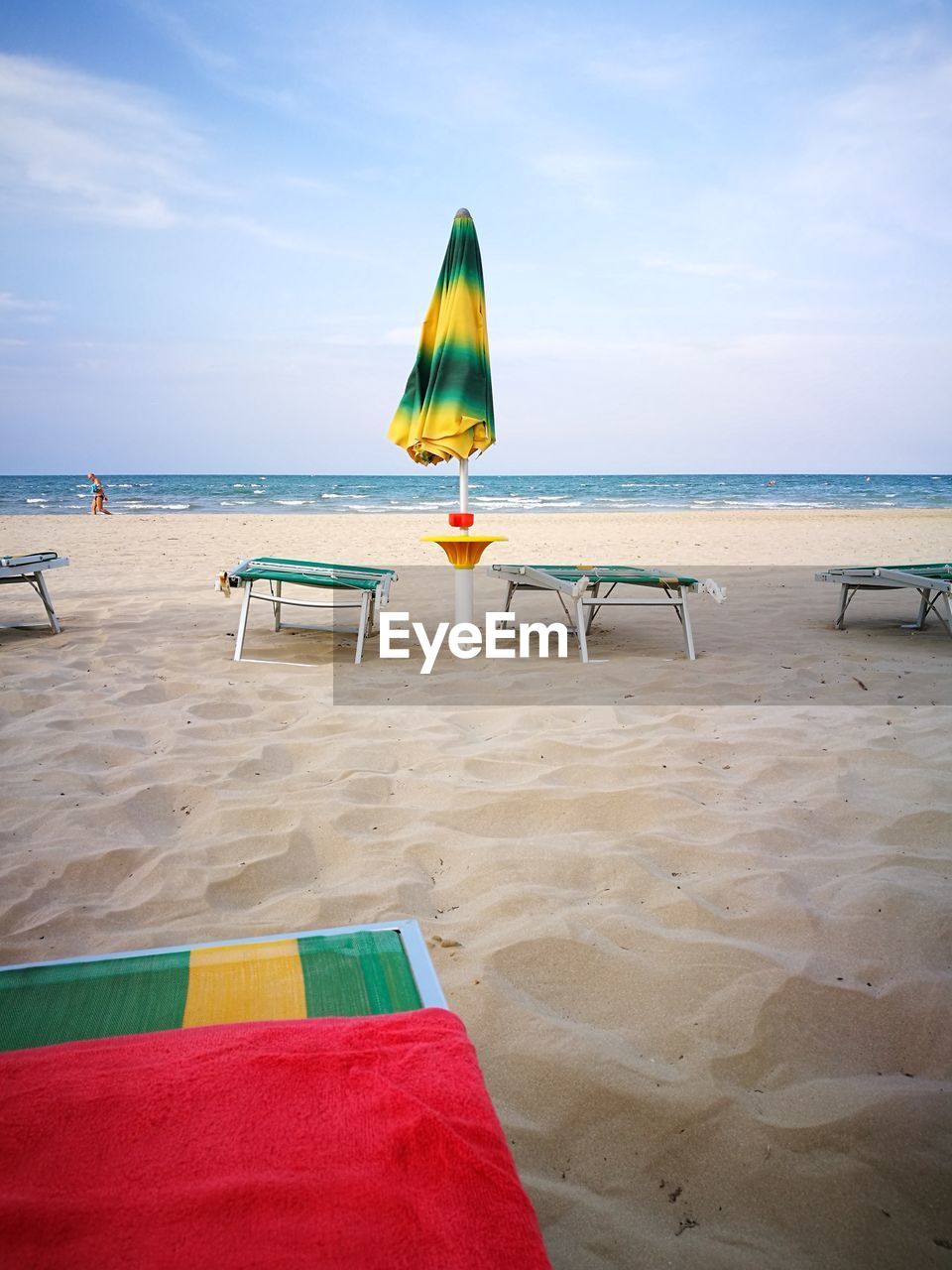 MULTI COLORED UMBRELLA ON BEACH