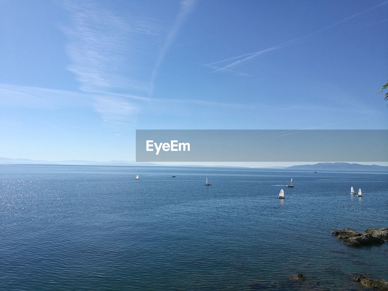 Scenic view of sea against blue sky