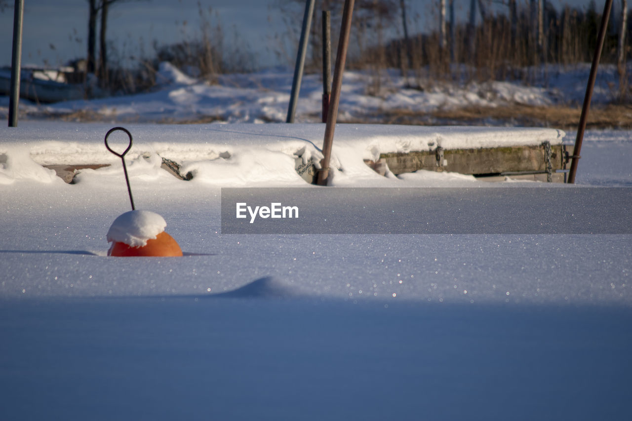 Boat harbor with snow and just buoys.