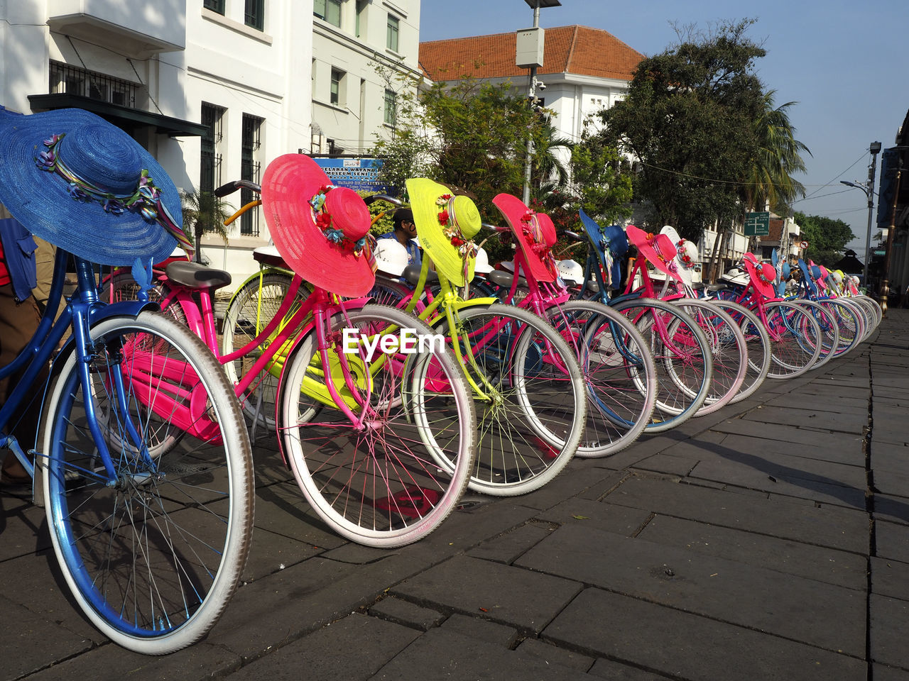 BICYCLES PARKED ON SIDEWALK BY BUILDING