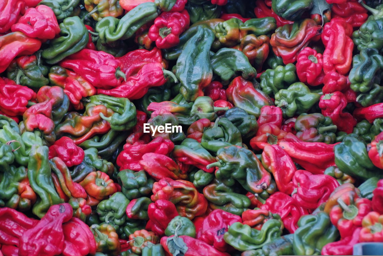 Full frame shot of red and green bell peppers for sale at market stall