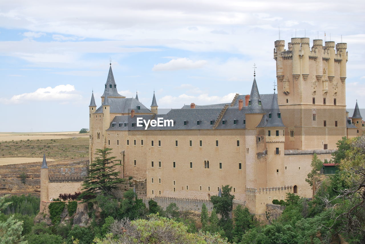 CASTLE BY TREE AGAINST SKY