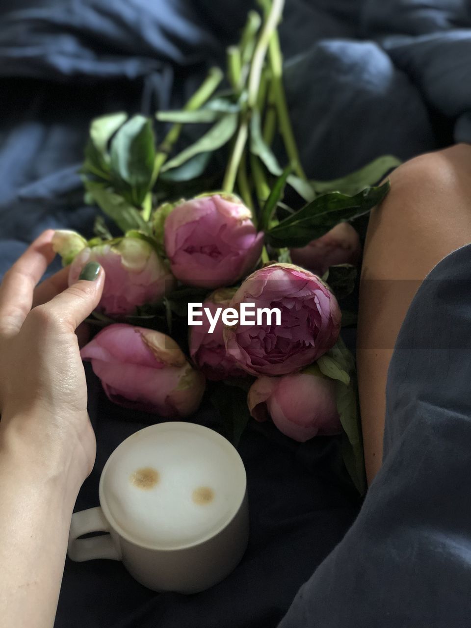 Coffee and flowers in bed