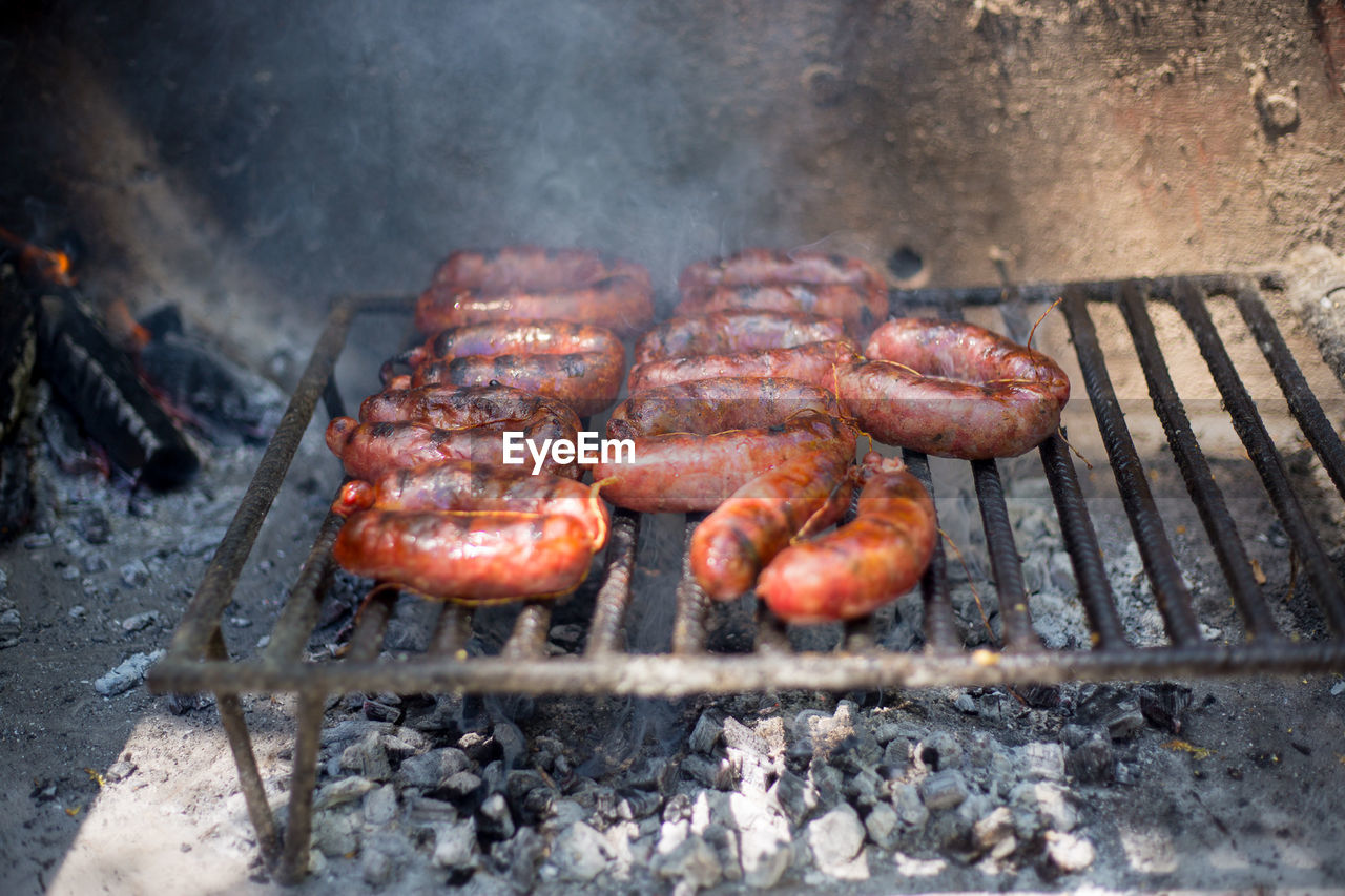 High angle view of chorizo grilling on barbecue