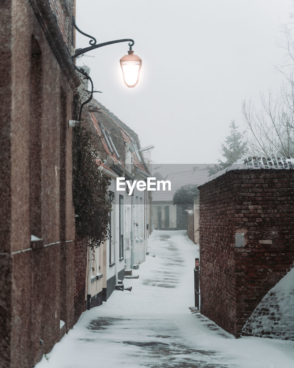 STREET AMIDST BUILDINGS AGAINST SKY