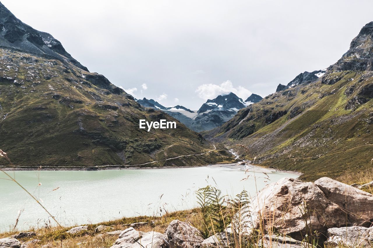 Scenic view of lake and mountains against sky