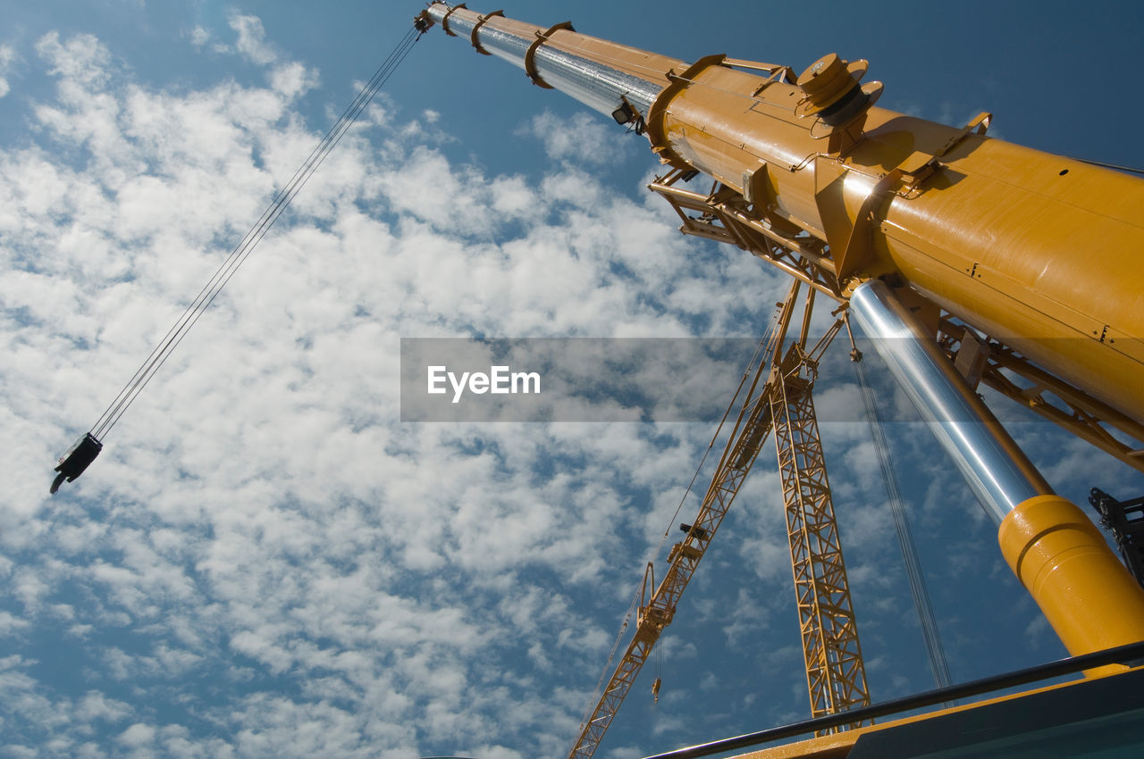 Low angle view of crane against sky