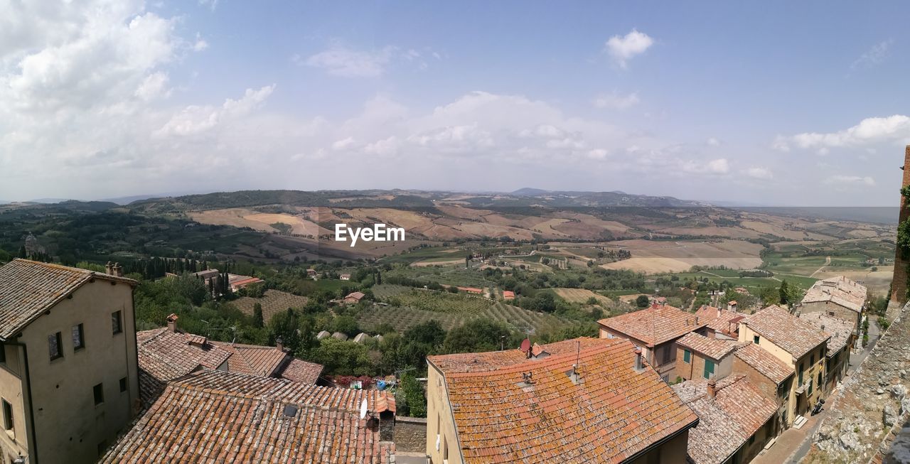 High angle view of houses in town against sky