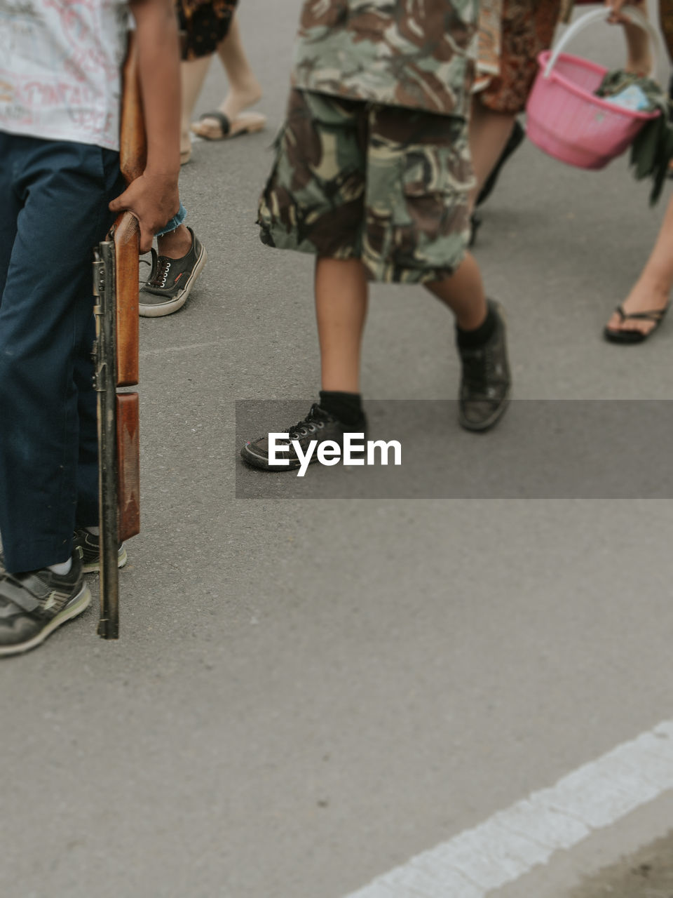 LOW SECTION OF PEOPLE WALKING ON STREET