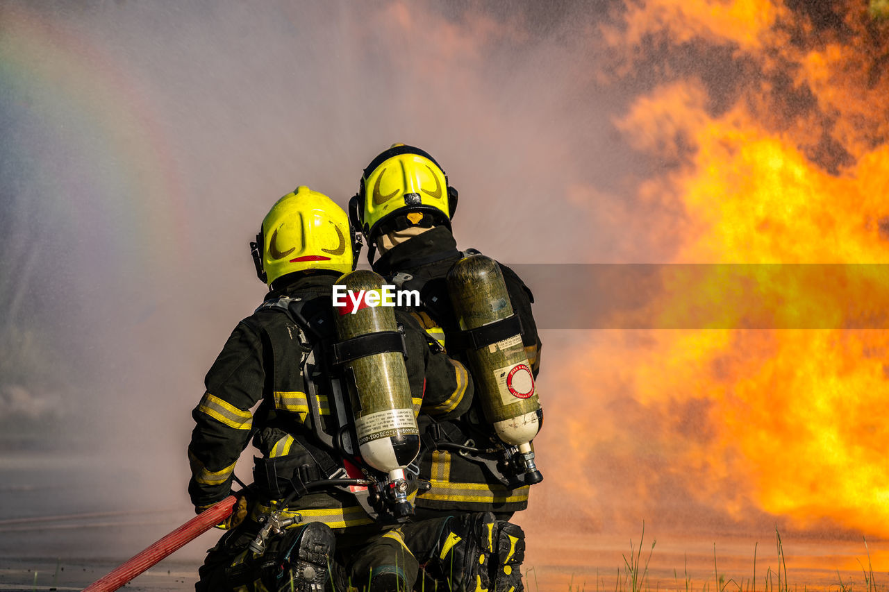 Firefighters are conducting fire drills by spraying water to extinguish the raging fire.