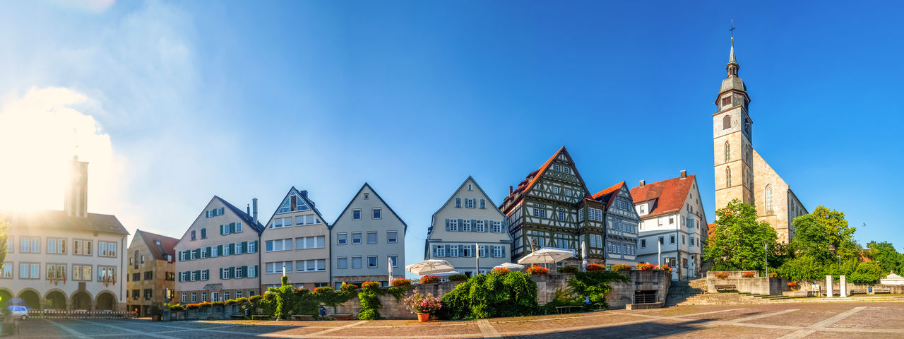 PANORAMIC SHOT OF BUILDINGS AGAINST BLUE SKY