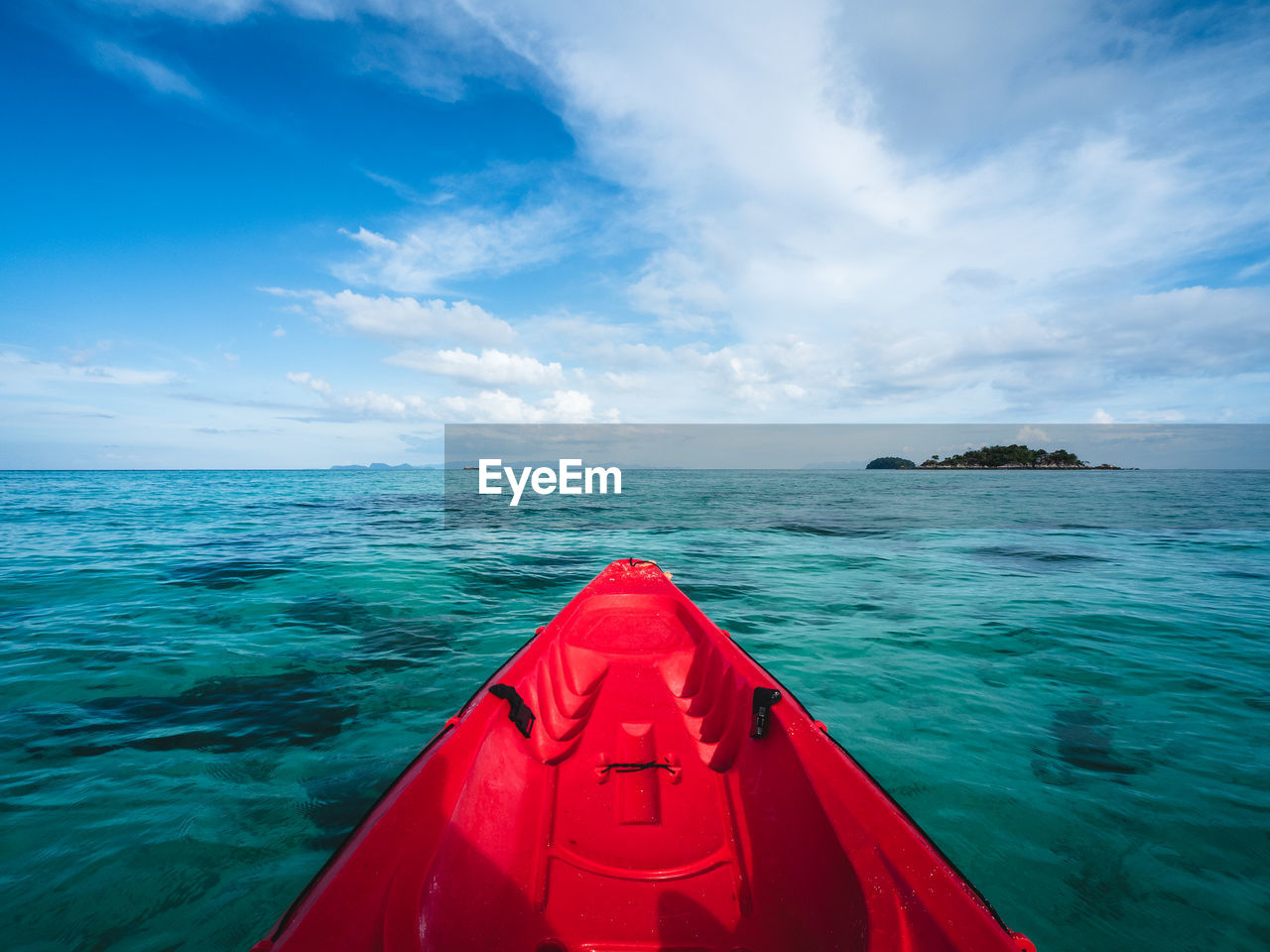First person view of kayak head to small island. float on turquoise sea. koh lipe island, thailand.