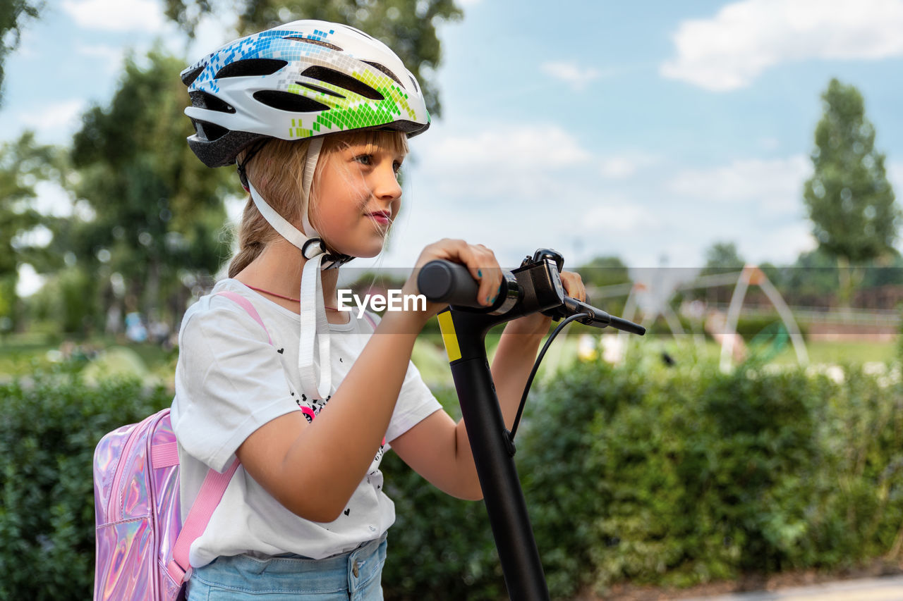 Close-up of girl riding push scooter