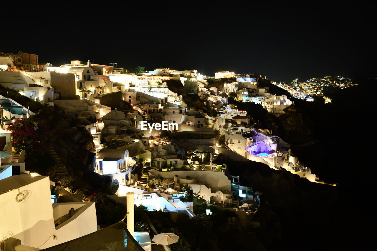 HIGH ANGLE VIEW OF ILLUMINATED BUILDINGS IN CITY