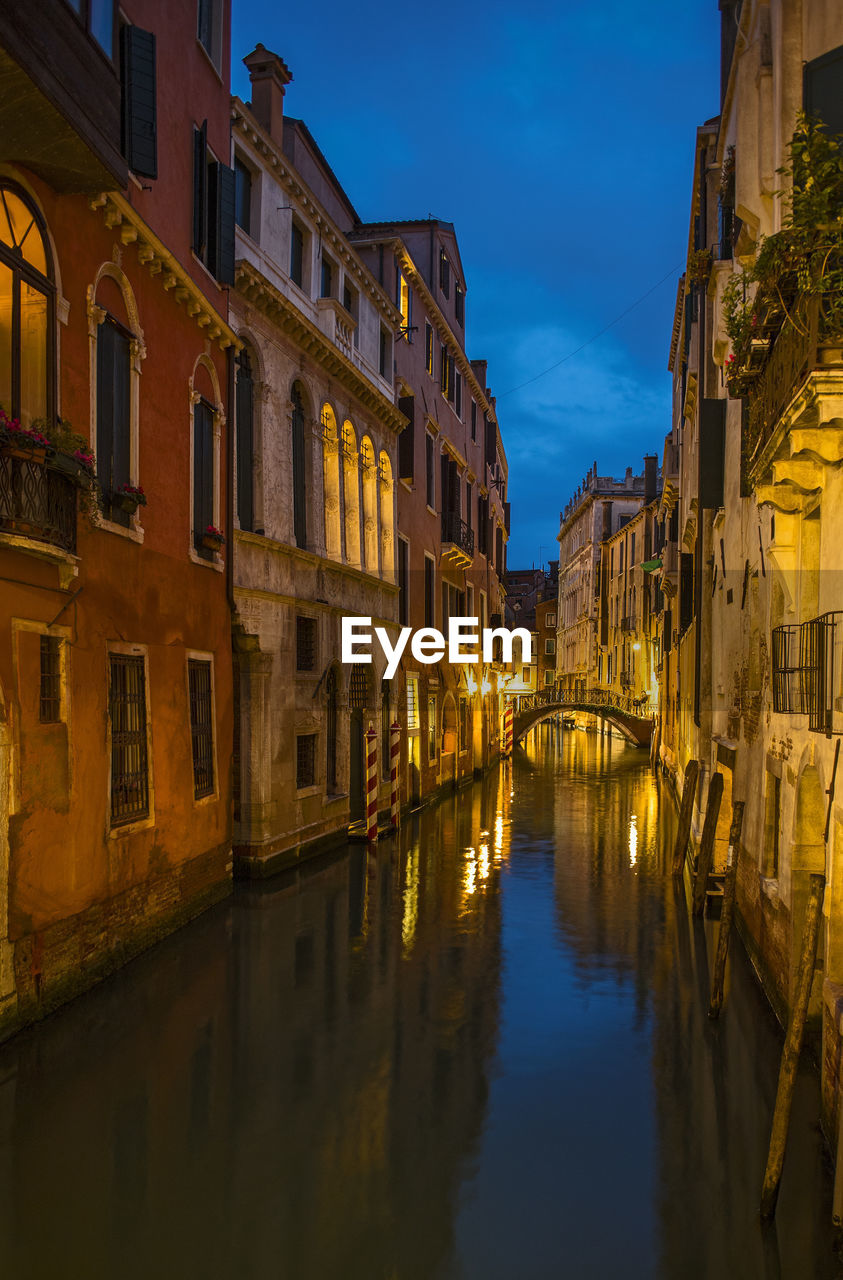 Narrow canal in venice after sunset