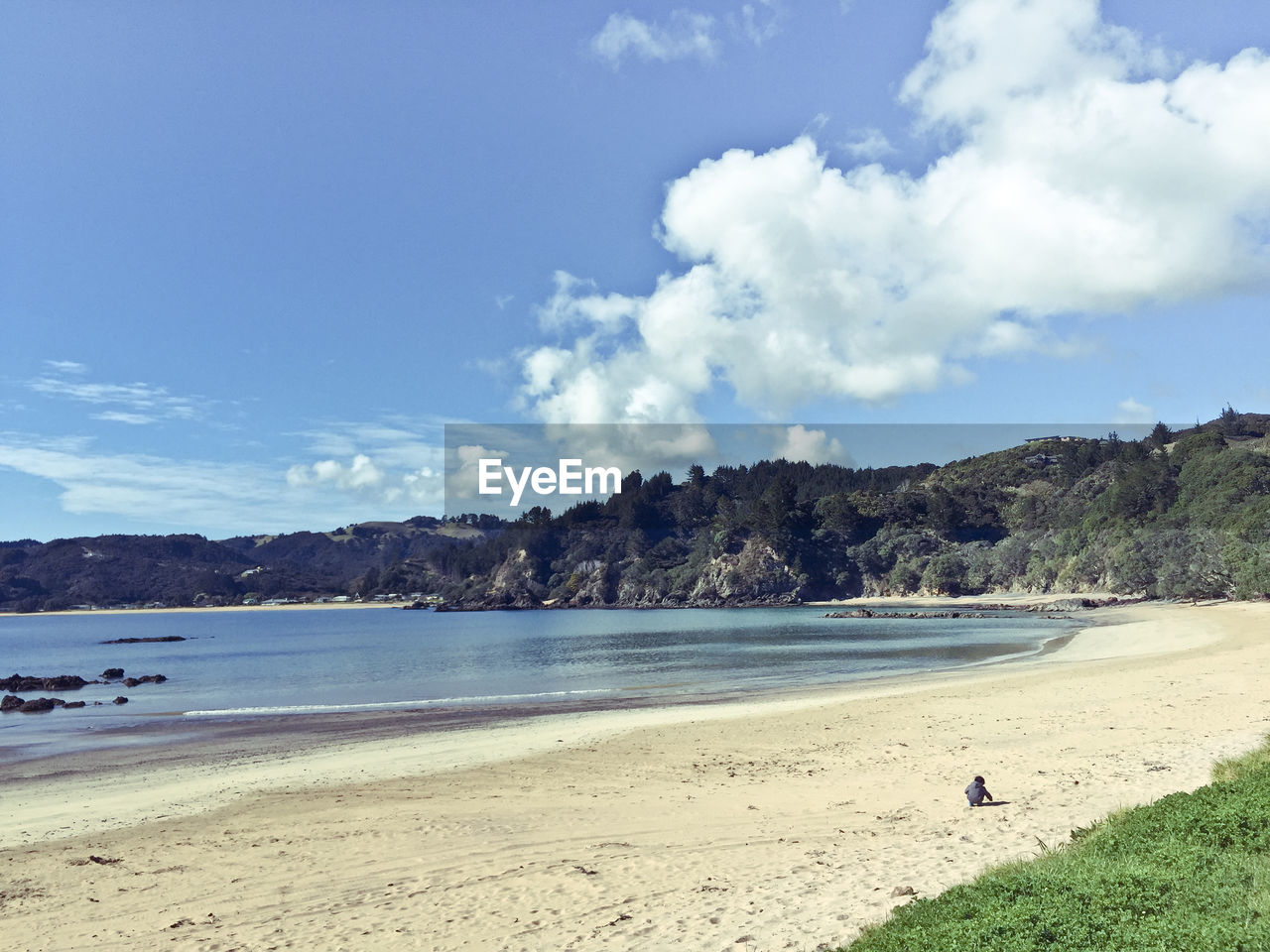 View of calm beach against blue sky