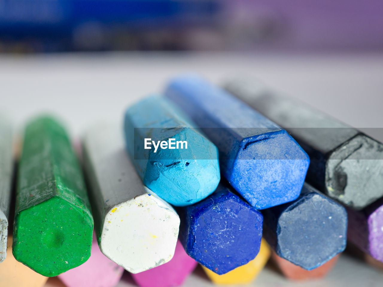 Close-up of multi colored pastel crayons on table