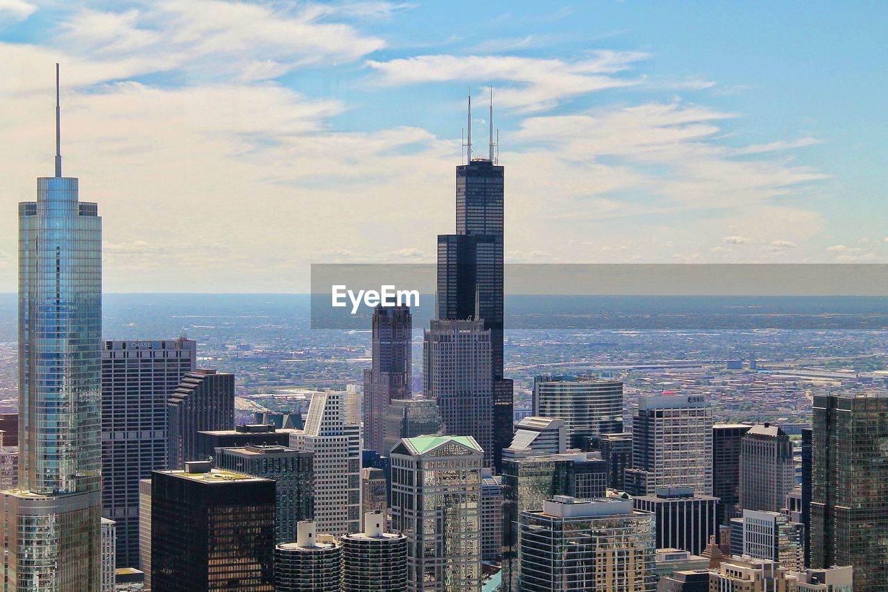 Urban skyline against cloudy sky