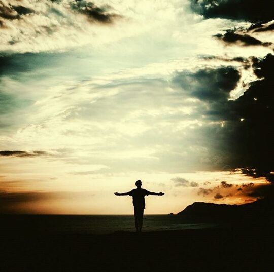 SILHOUETTE OF WOMAN STANDING ON BEACH