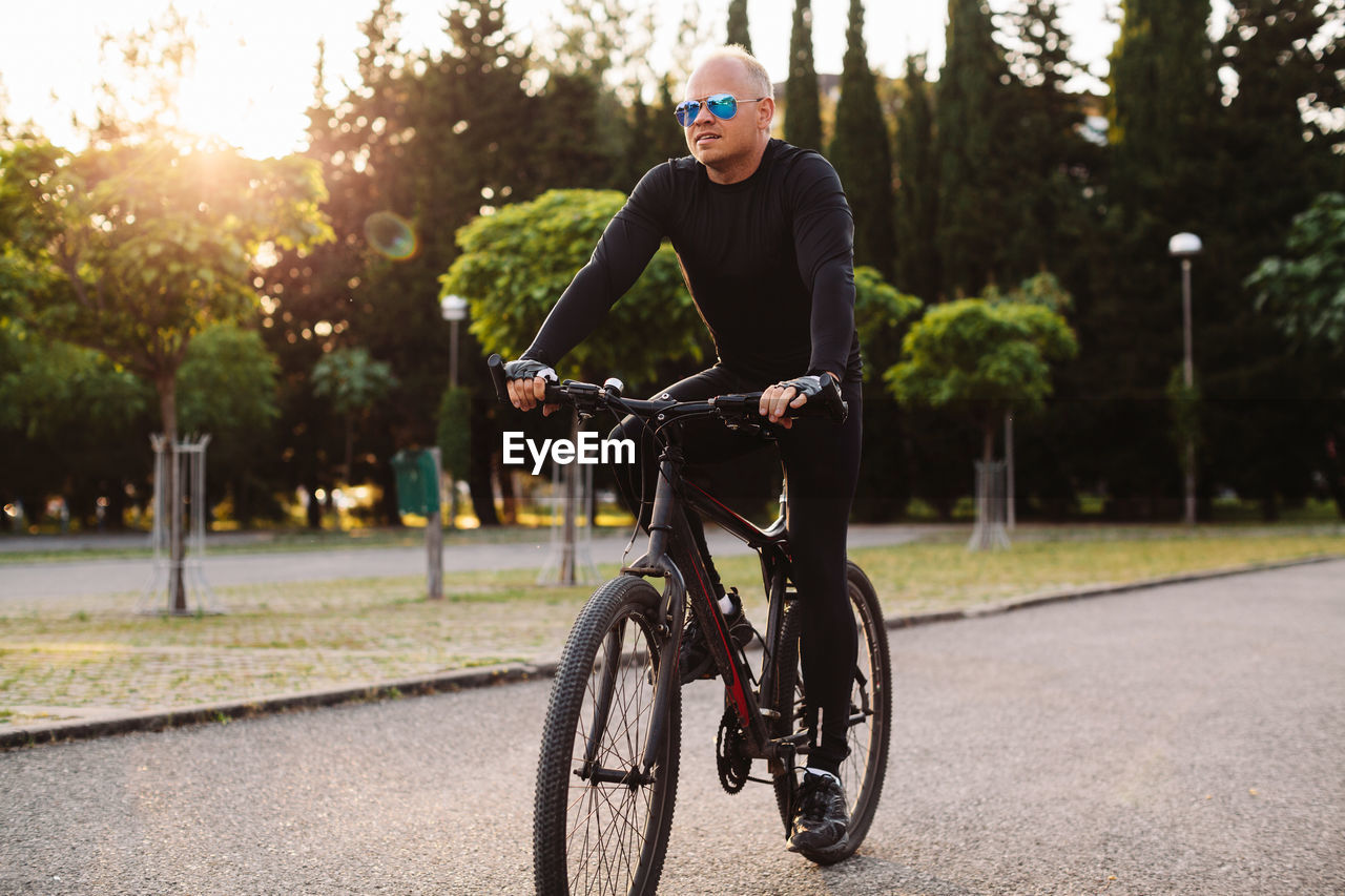 Man riding bicycle on road