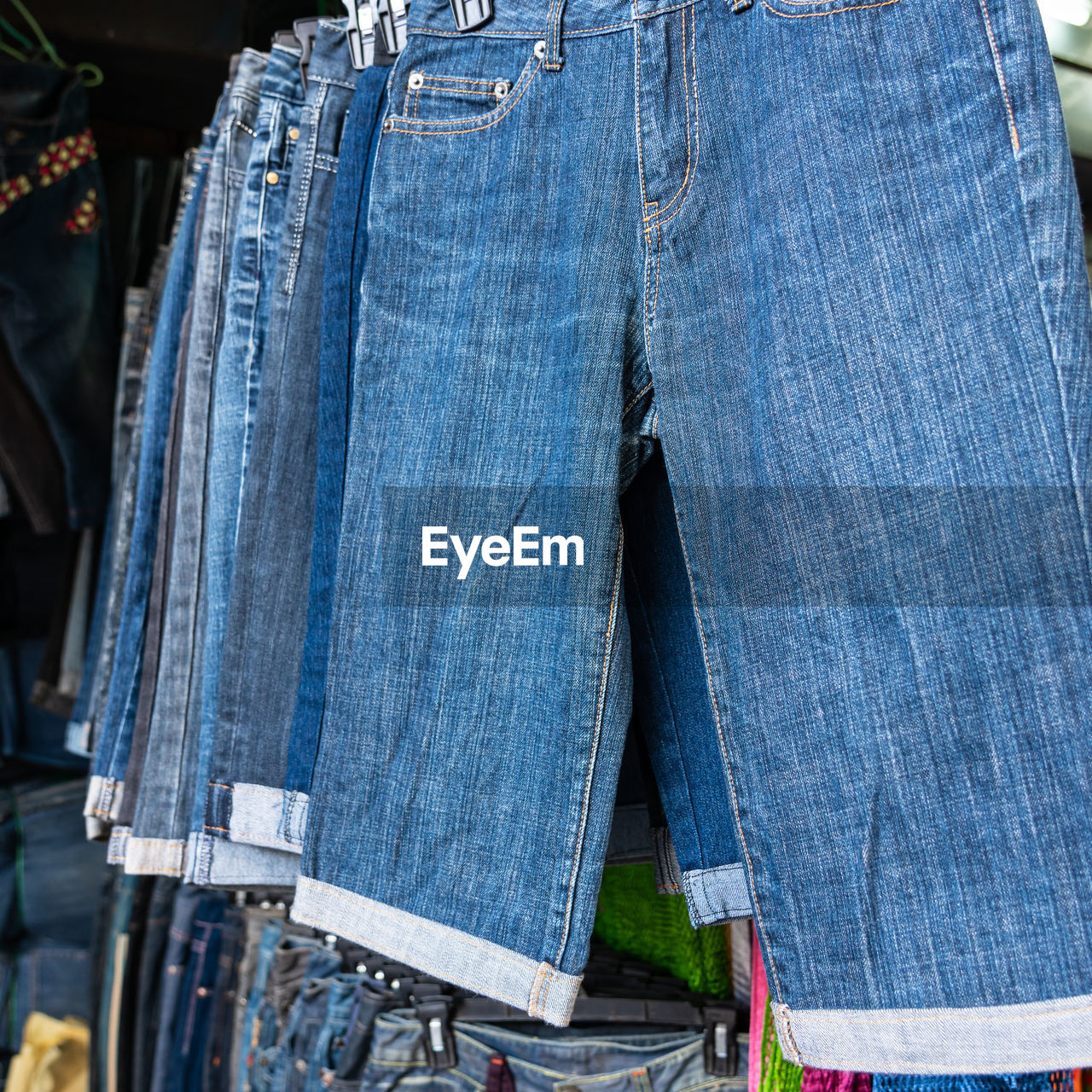 CLOSE-UP OF CLOTHES HANGING ON MARKET