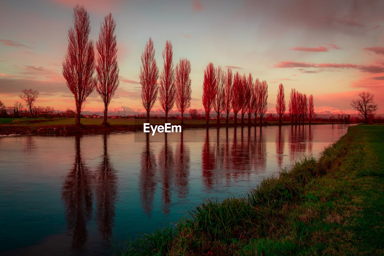 Sunset along the man-made canal po valley italian landscape