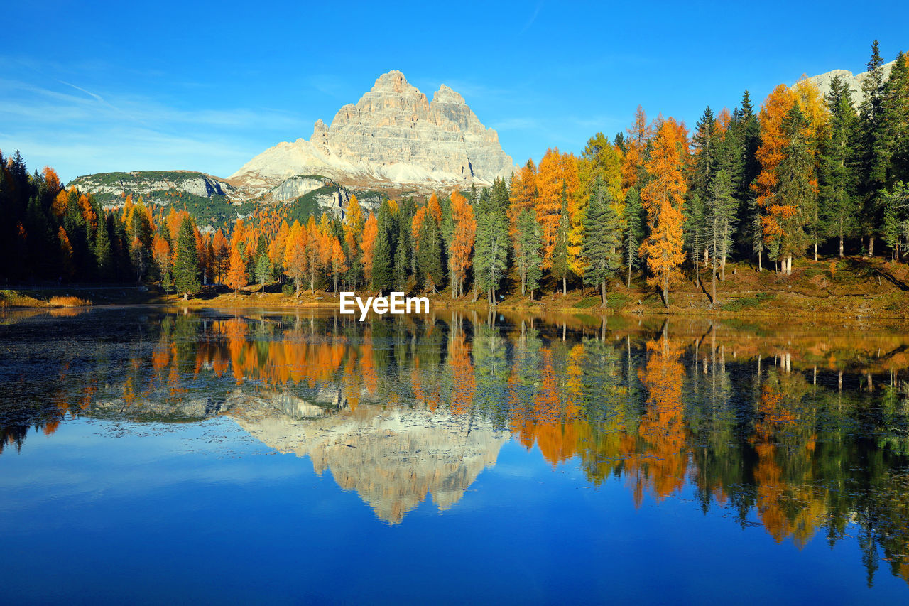 Reflection of trees in lake against sky during autumn