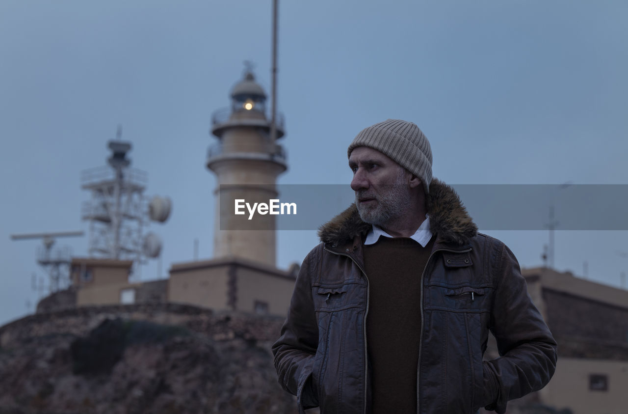 Portrait of adult man in leather jacket with lighthouse. almeria, spain