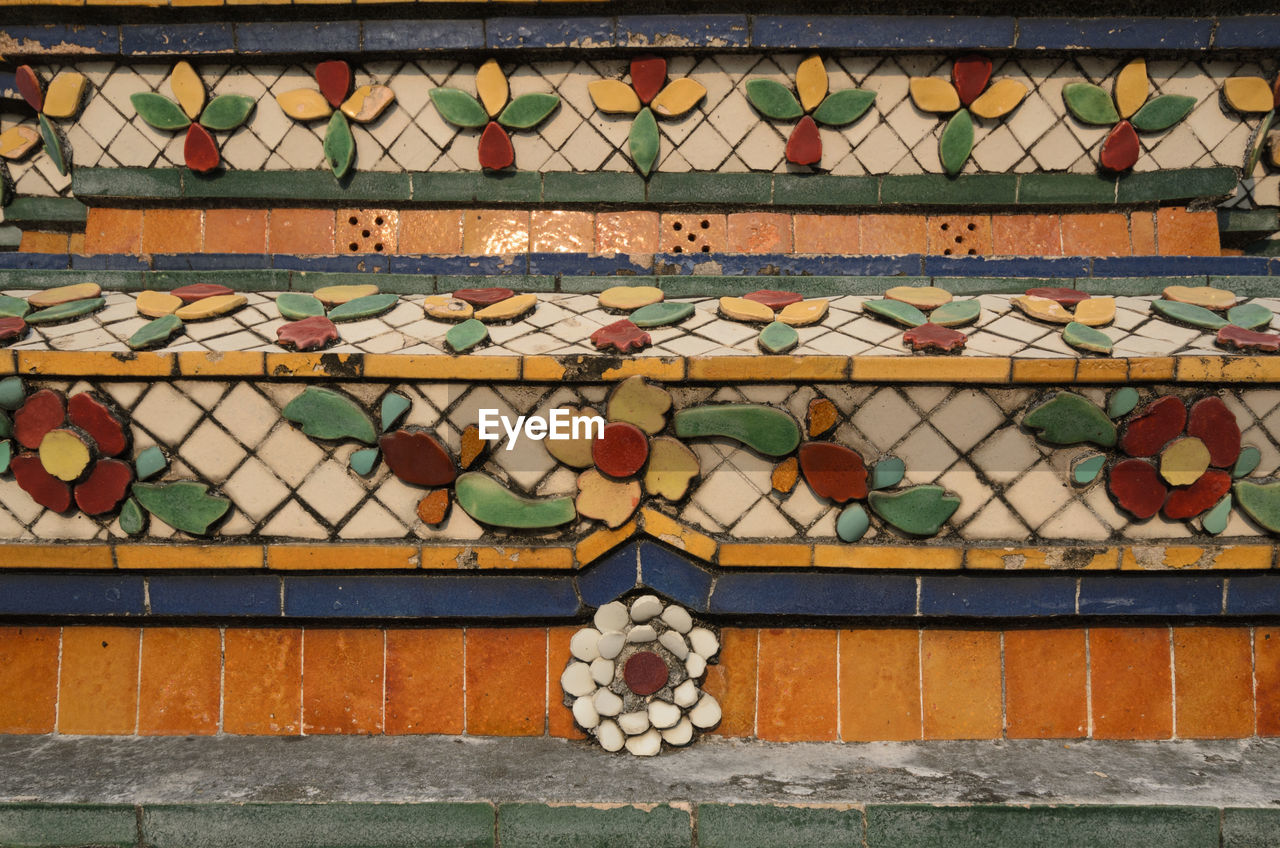 Full frame shot of colorful floral pattern tiles on wall at wat pho