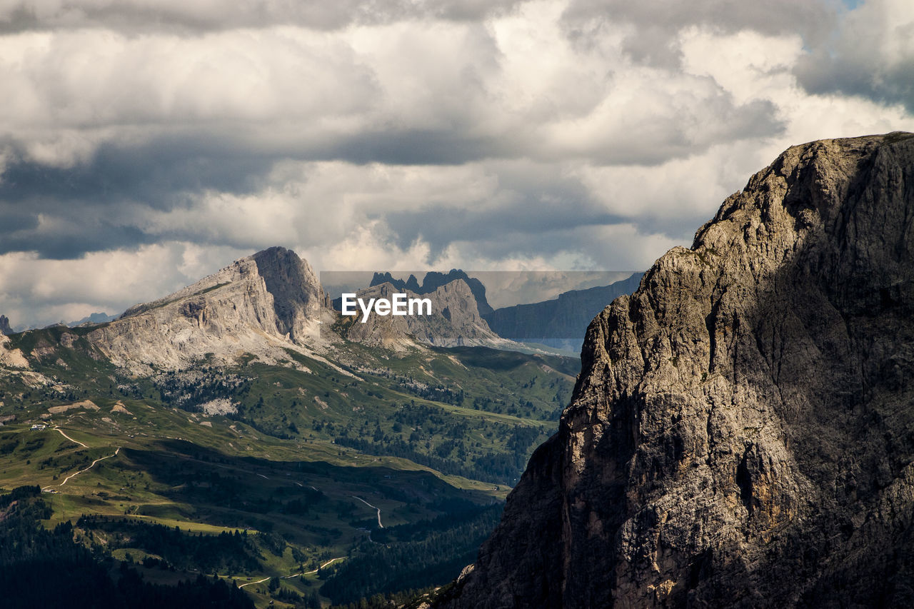 Scenic view of dolomites against cloudy sky