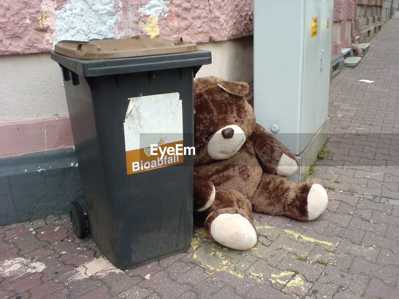 High angle view of teddy bear by garbage bin on street