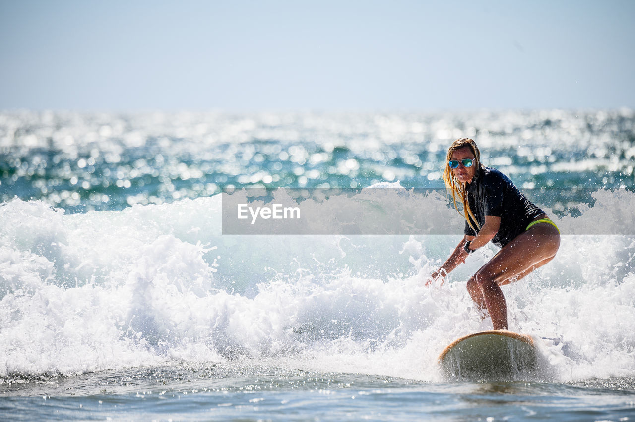 Woman surfing on sea