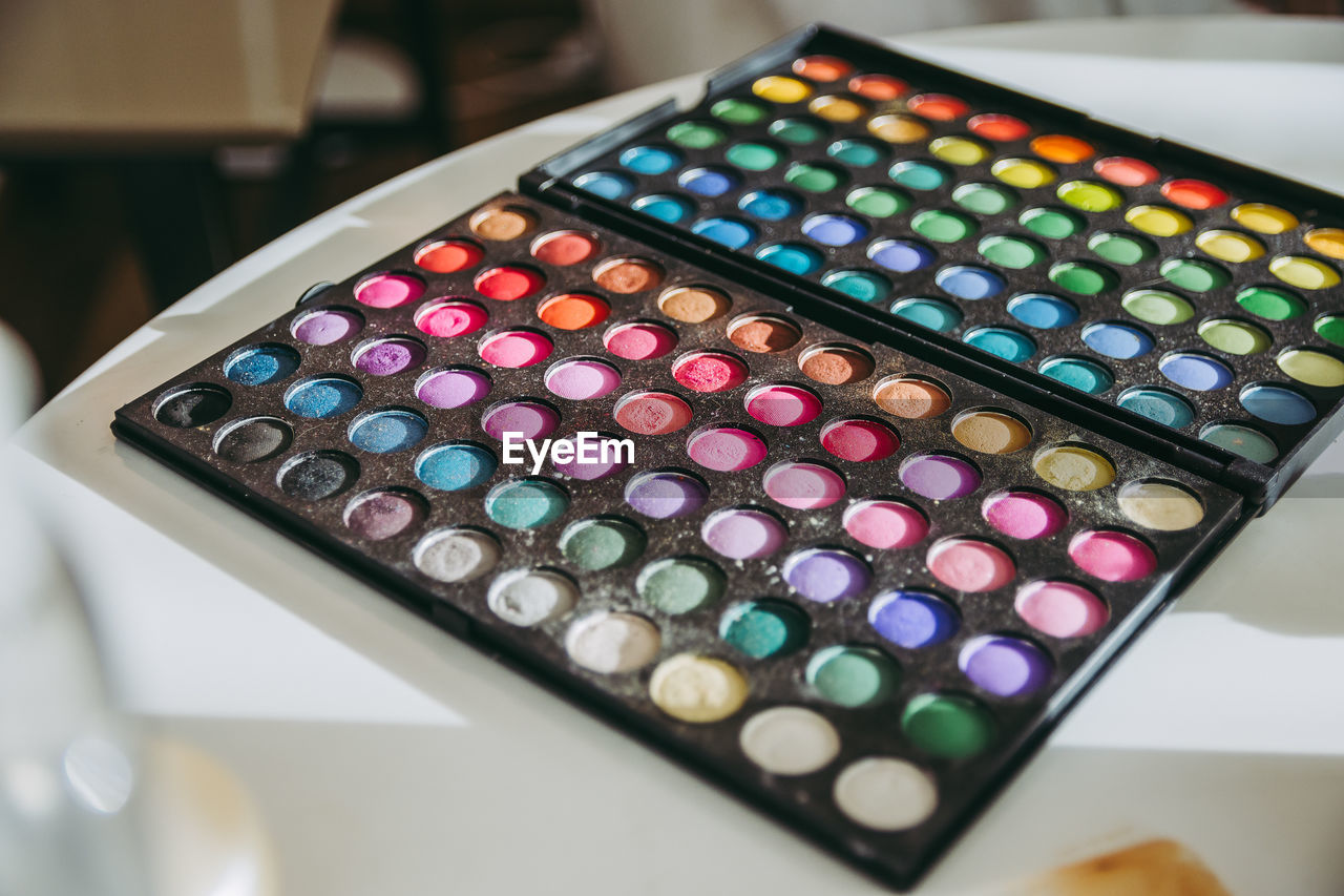 High angle view of multi colored makeup on table