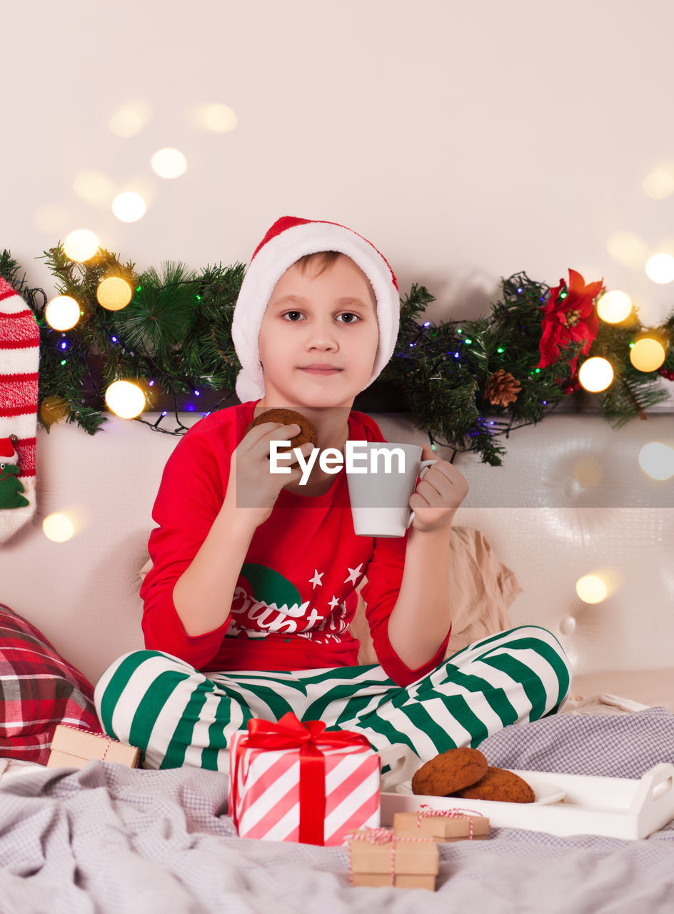 portrait of cute girl playing with christmas tree